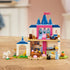 LEGO Disney Princess Cinderella Animal Friends Castle in blue, pink, white, and tan plastic stands assembled on a wooden table with Cinderella and four animal figures.