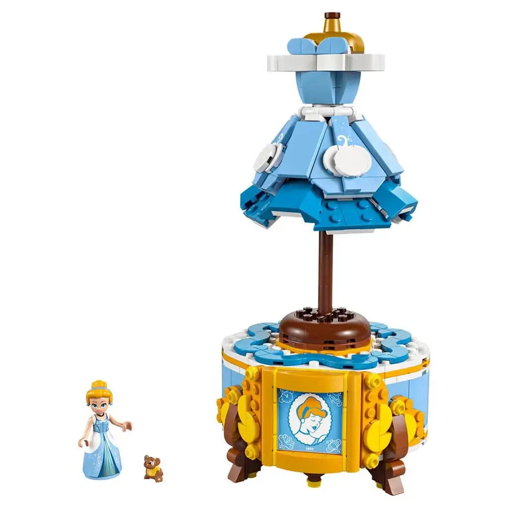 LEGO Disney Princess Cinderella dress display in blue, white, gold and brown plastic with mannequin-style gown above a decorative cabinet, plus Cinderella and mouse figures on a white background.