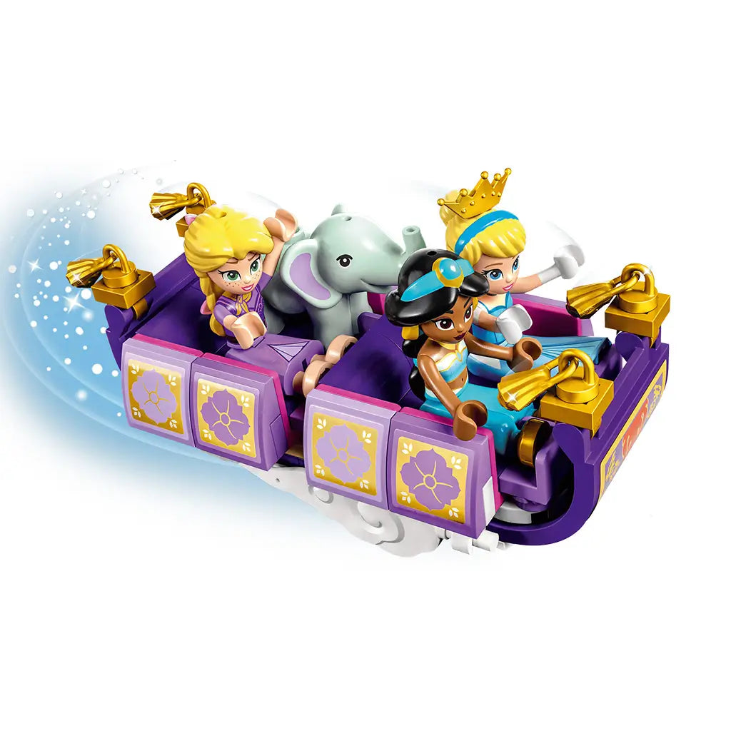 LEGO Disney Princess flying carpet in purple and gold plastic carries Rapunzel, Jasmine, Cinderella and a small elephant, shown in motion against a white background.
