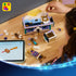 LEGO Disney Princess Jasmine's Jewelry Box in teal, lavender, white, and gold plastic sits partly assembled on a wood table as a child builds beside tablet instructions and figures.
