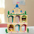 LEGO Disney Princess Mini Belle and Tiana Castle fully built, featuring tan columns, pastel archways, blue spires, balcony railings, and character figures displayed against a softly lit room backdrop.