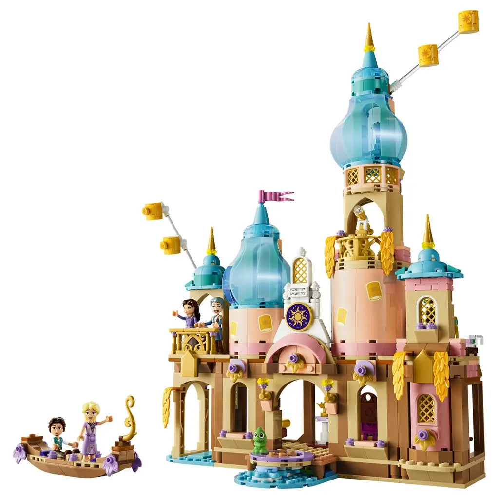 LEGO Disney Princess Rapunzel's Castle in tan, pink, turquoise, and gold plastic features tall domed towers, ornate arches, character figures, a small boat, and palace play areas.