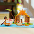 LEGO Disney Moana Village House & Boat in tan, orange, green, and pink plastic shows the completed tropical house, canoe, two Moana figures, pig, palm tree, and fish.