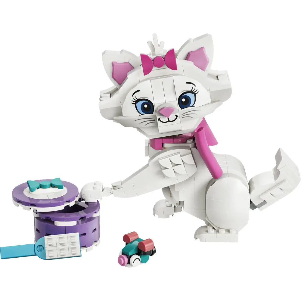 LEGO Disney Aristocats Marie building toy featuring white plastic bricks, smooth rounded cat shapes, pink bow and collar, bright blue eyes, poseable tail and paws, with yarn and accessory pieces on a white background.