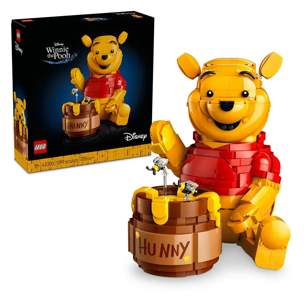 LEGO Disney Winnie the Pooh display set in yellow and red plastic, completed bear figure with honey pot and bees, product shown with retail box on a clean studio background.