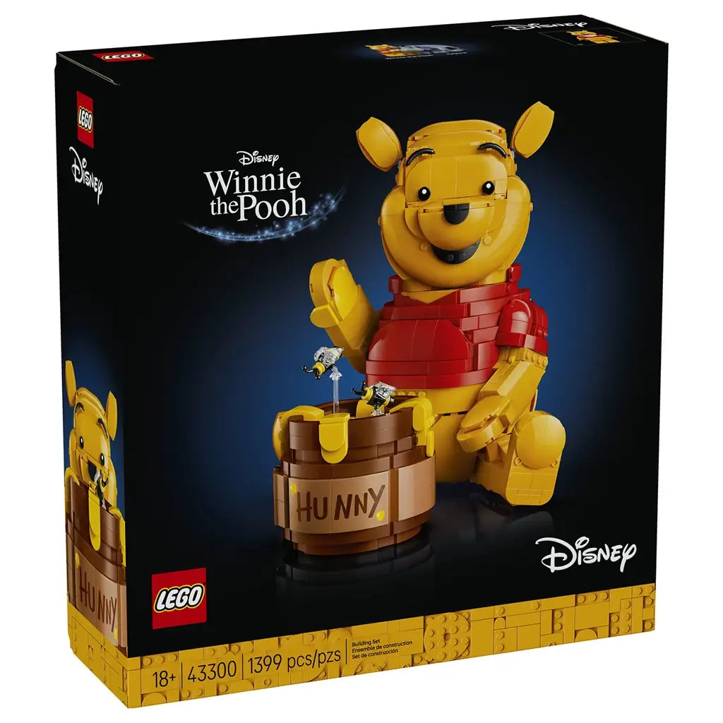 LEGO Disney Winnie the Pooh set in yellow and red plastic, rounded bear figure with honey pot and bees, decorative display toy shown on branded retail box against a dark background.