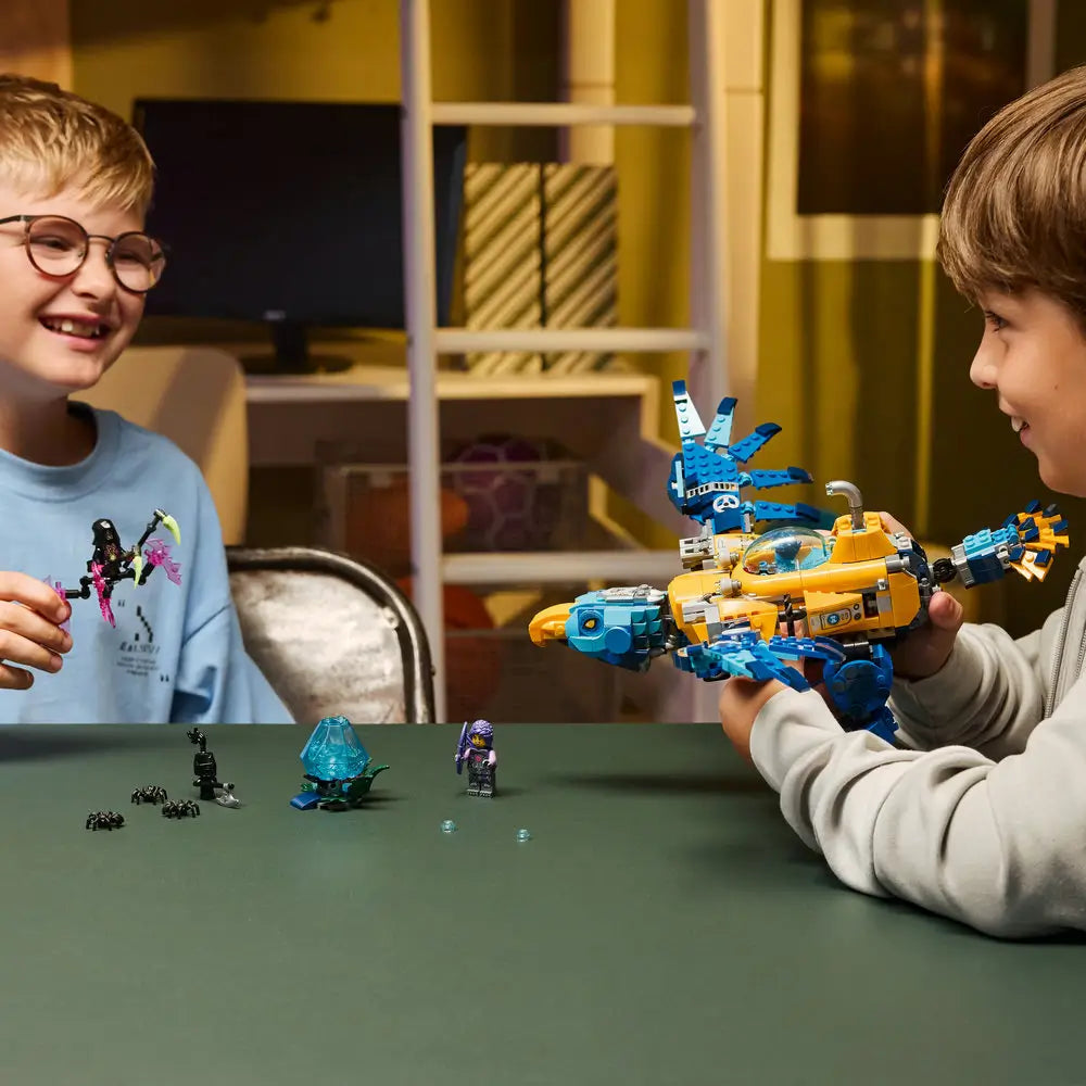 LEGO DREAMZzz lifestyle builder scene shows two children smiling while holding and playing with the Crocodile Submarine, highlighting interactive building, imaginative storytelling, and shared creative play.