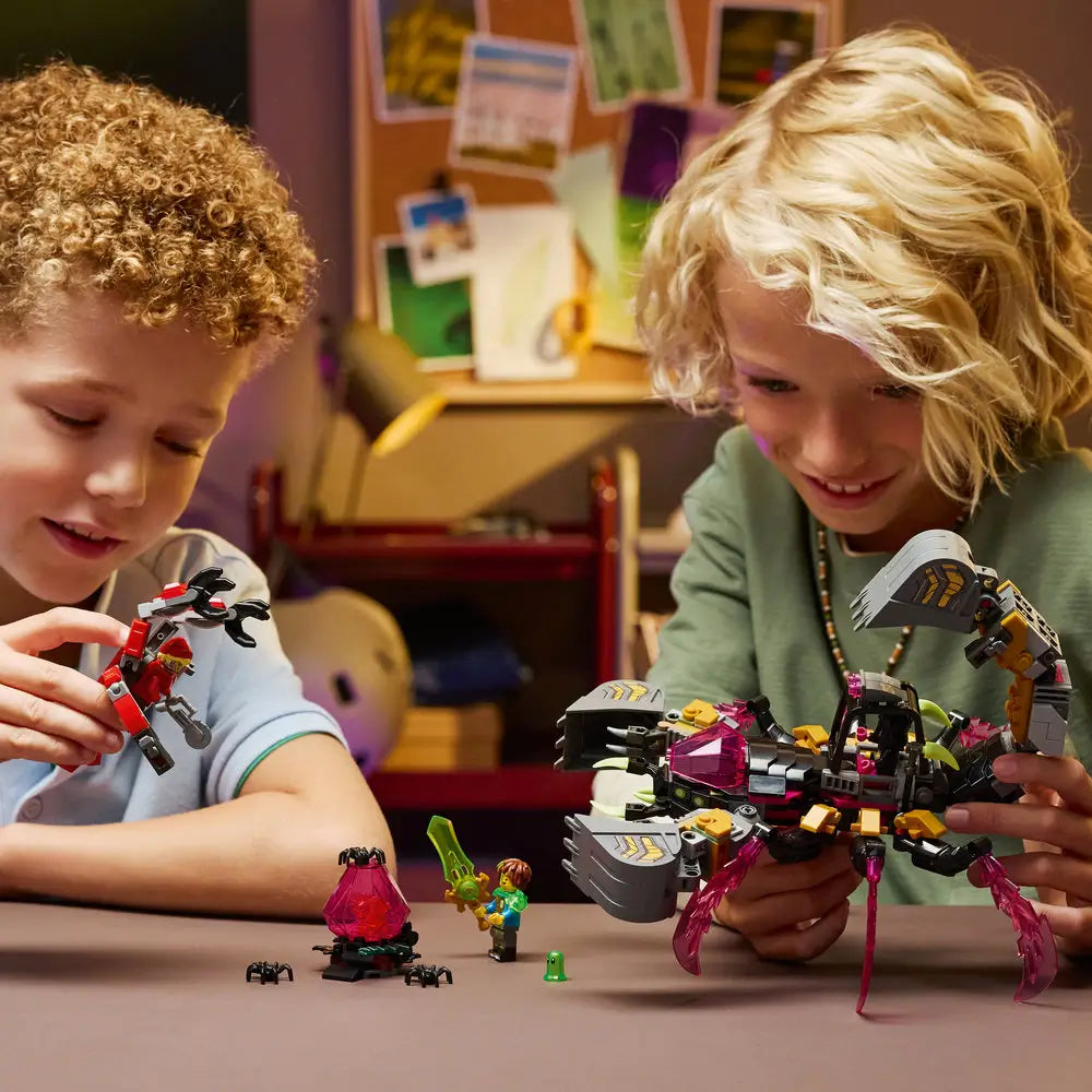 LEGO DREAMZzz Nightmare Scorpion Digger builder scene showing two children focused on assembling the dark gray scorpion mech with gold accents, pink crystals, minifigures, and guide pages.