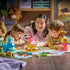 LEGO DUPLO Animal Building Game play scene shows two children and an adult building colorful plastic flamingo and giraffe figures with a blue whale on a table.