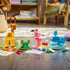 LEGO DUPLO Animal Building Game figures include a yellow giraffe, green frog, pink flamingo and blue whale with loose plastic bricks and cards on a wood floor.