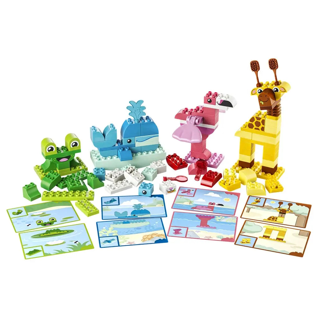 LEGO DUPLO Animal Building Game 10472 features green, blue, pink and yellow plastic animal builds with matching picture cards and loose bricks arranged on white.
