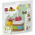 LEGO DUPLO Celebration Cake box front, light green and cream cardboard packaging with a glossy finish, rectangular hanging pouch shape, featuring the colorful brick-built cake model, 1½+ age marking, 9-piece count, and 4-in-1 build options.