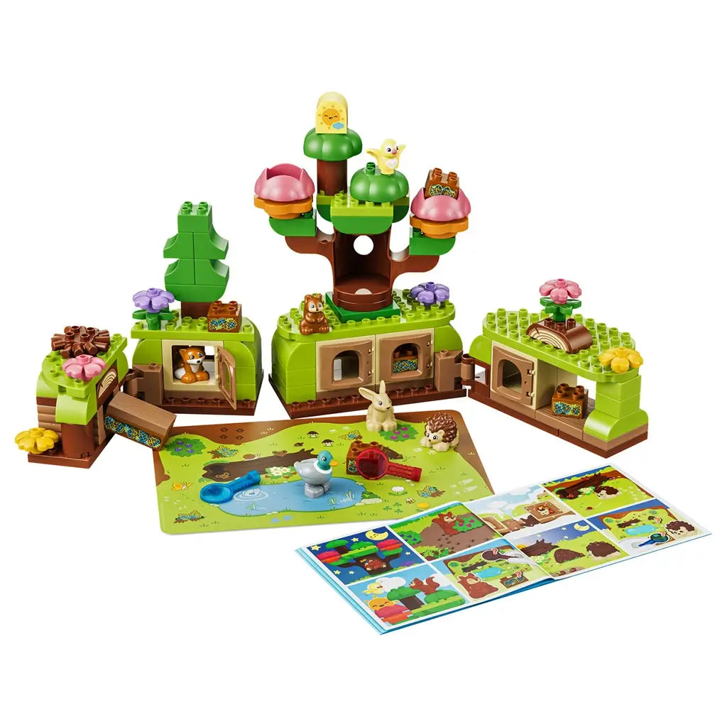 LEGO DUPLO Discovery Forest with Wild Animals set 10480 displays green and brown forest habitats, pink and purple flowers, five animal figures, magnifiers and picture cards.