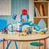 LEGO DUPLO Marvel Spidey Webquarters playset features a blue plastic headquarters with slide, web, vehicles, figures and accessories displayed on a wooden table.