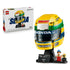 LEGO Ayrton Senna Helmet set 43024 pairs its white product box with a yellow, green and blue brick-built racing helmet on a black stand, plaque, minifigure and mini helmet.