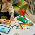 LEGO Cristiano Ronaldo soccer building set features red, green, gold and black plastic brick components being assembled beside digital instructions, with figure sections, backdrop pieces and ball elements.