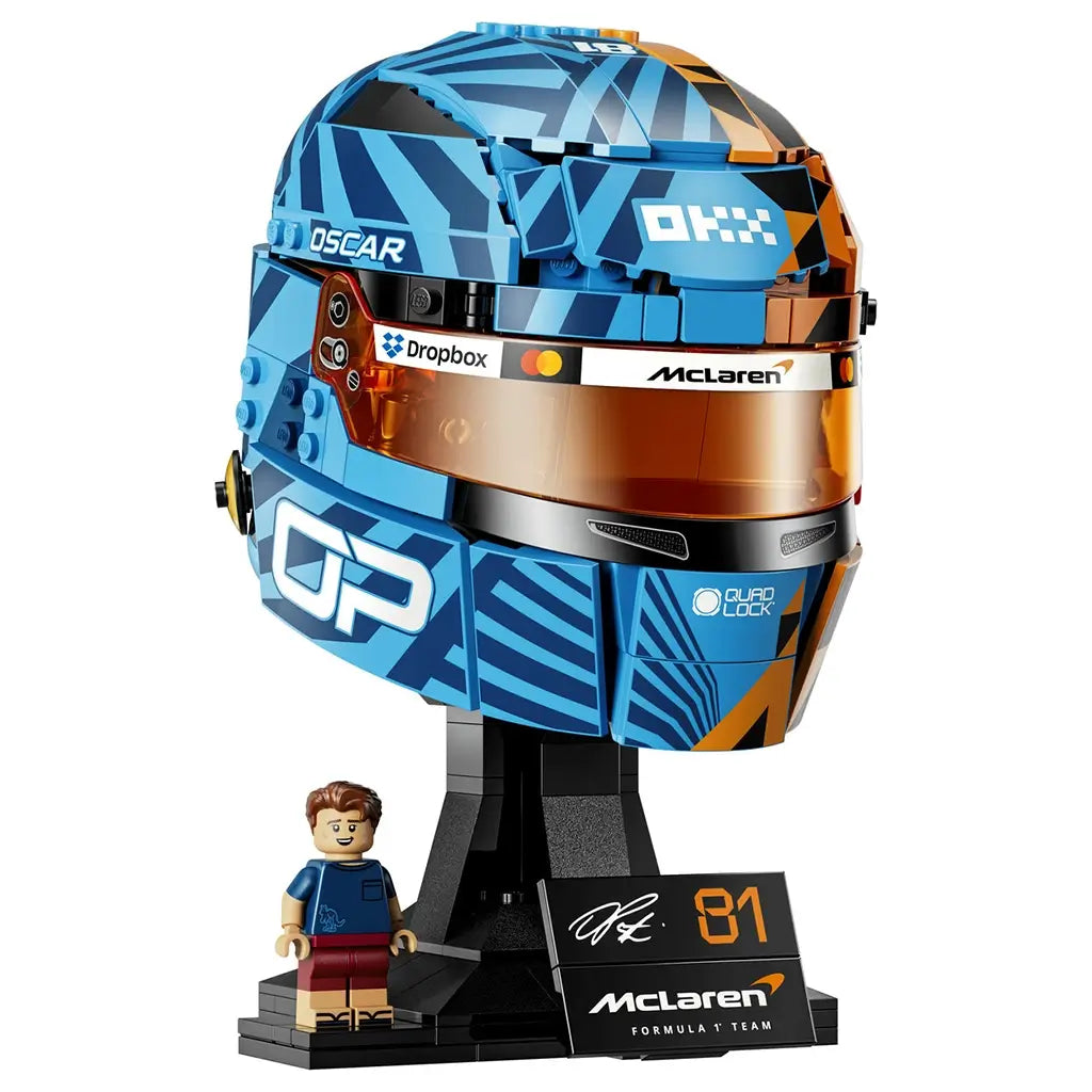 LEGO McLaren Formula 1 helmet collectible features blue, orange and black plastic brick construction shaped as Oscar Piastri’s racing helmet with tinted visor, display stand and matching minifigure.