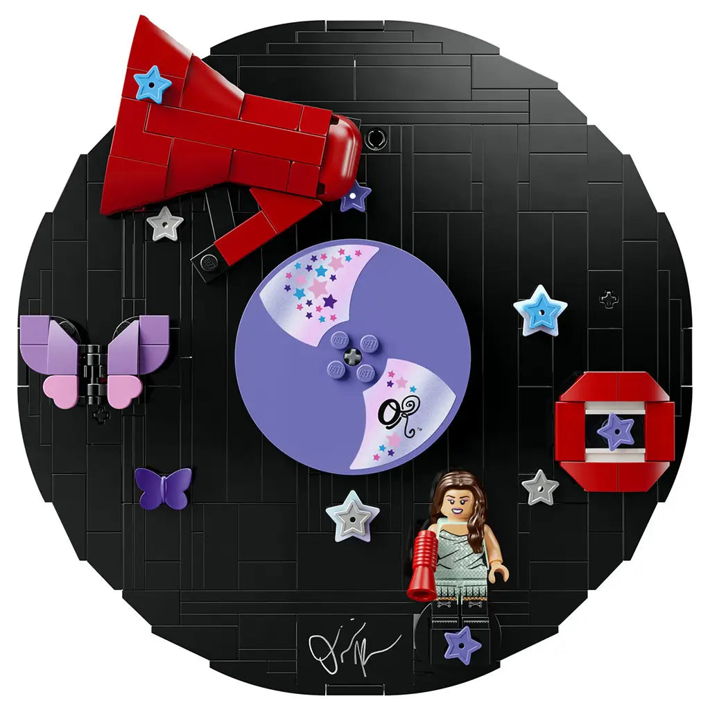 LEGO Olivia Rodrigo Vinyl display in black bricks forms a round record with a purple disc, red megaphone, pastel butterflies, stars and singer minifigure on white.