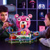 LEGO Fortnite Rave Cave in pink, white and purple plastic bricks is used for play by two builders, with a bear-shaped venue, looping rail track, vehicle and minifigures.