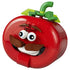 LEGO Fortnite Tomatohead set in red, green and brown plastic bricks, shaped as a smiling tomato head with wide eyes, mustache, white teeth and leafy stem on white.