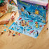 LEGO Friends Advent Calendar 2026 features colorful plastic winter mini builds as a child assembles a festive piece beside the opened snowy calendar playmat on a wood table.