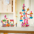 LEGO Friends Candy & Cupcake Ferris Wheel 42700 in pink, blue, and white plastic features candy gondolas, two colorful snack stands, and three mini-dolls on a bright tabletop.
