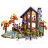 LEGO Friends Cozy Fall Forest Cabin set features a brown and tan lodge with purple roof, gray chimney, autumn trees, rocky stream, figures, bicycle and woodland animals.
