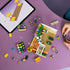 LEGO Friends Creative Flower Shop set in green, pink and white plastic, partly assembled with loose floral pieces beside digital building instructions on a tablet.