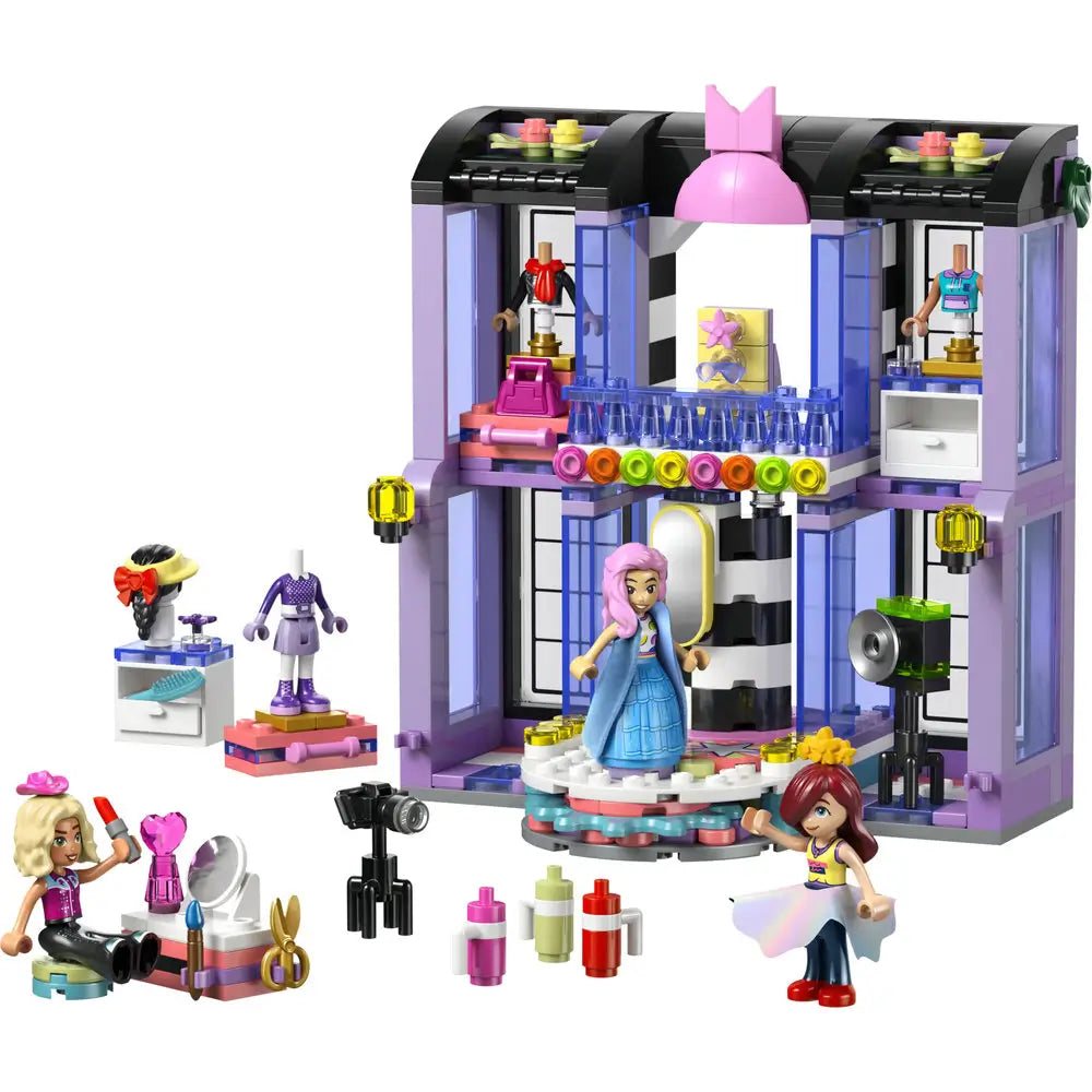 LEGO Friends fashion show playset featuring purple and lavender plastic bricks forming a two story runway building with rotating stage, spotlights, accessories, and minifigures designed for creative fashion play indoors.