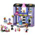 LEGO Friends fashion show playset featuring purple and lavender plastic bricks forming a two story runway building with rotating stage, spotlights, accessories, and minifigures designed for creative fashion play indoors.