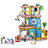 LEGO Friends Heartlake City Friends Club House toy features bright blue, pink, and yellow plastic bricks forming a rounded three story building with slide, café, tech room, mini dolls, and playful city club setting.