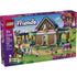 LEGO Friends Horse Stable and Riding Academy box shows tan and blue barn with horses, riders, jumps, pets, and accessories, displayed on branded packaging highlighting ages seven plus and 735 piece count.