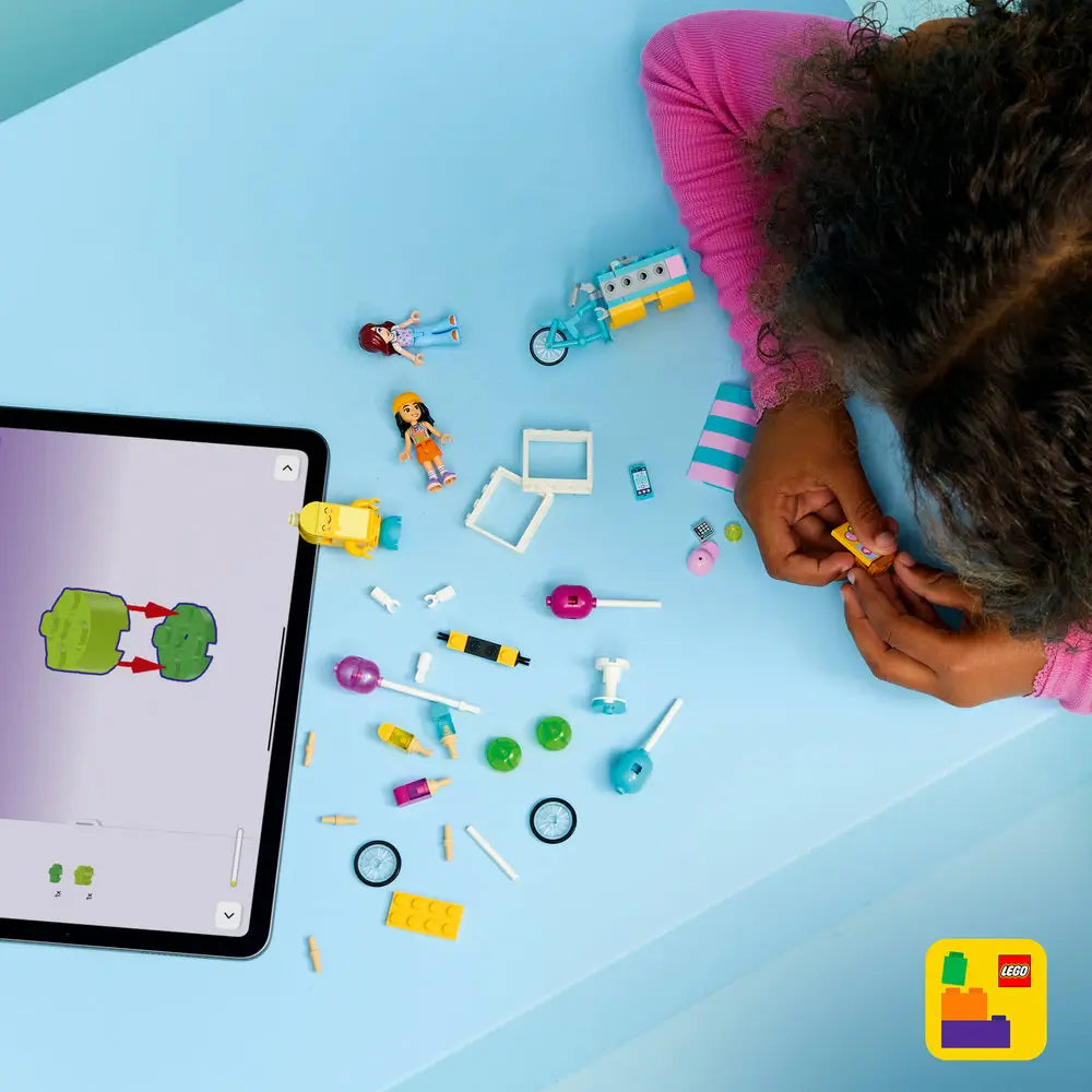 LEGO Friends ice cream and balloon stand set shown with pieces and characters highlighted, including bicycle cart parts, balloon elements, popsicles, and minidolls, displayed against a bright graphic background to showcase playful features.