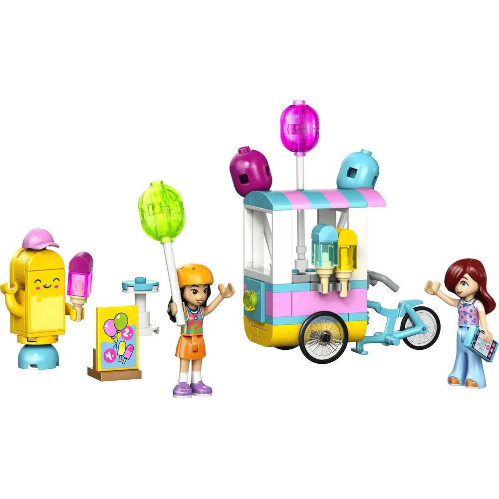 LEGO Friends ice cream and balloon stand playset built in pastel pink, teal, yellow, and white plastic bricks, featuring a bicycle cart with striped canopy, colorful balloons, popsicles, and minidoll characters on a clean white background.