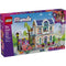 LEGO Friends Liann’s Family House box front featuring a purple package with illustrated pastel brick house, minifigures, ramp, trees, and accessories, highlighting a creative building toy for kids ages seven and up.