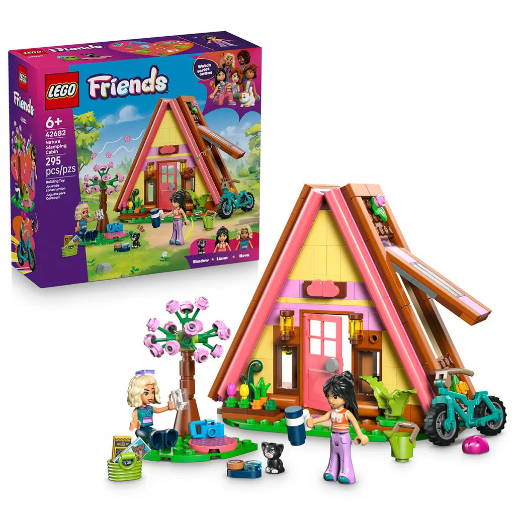 LEGO Friends Nature Glamping Cabin 42682 in pink, yellow and brown plastic, with A-frame cabin, two mini-dolls, black cat, teal bike, flower tree and retail box.