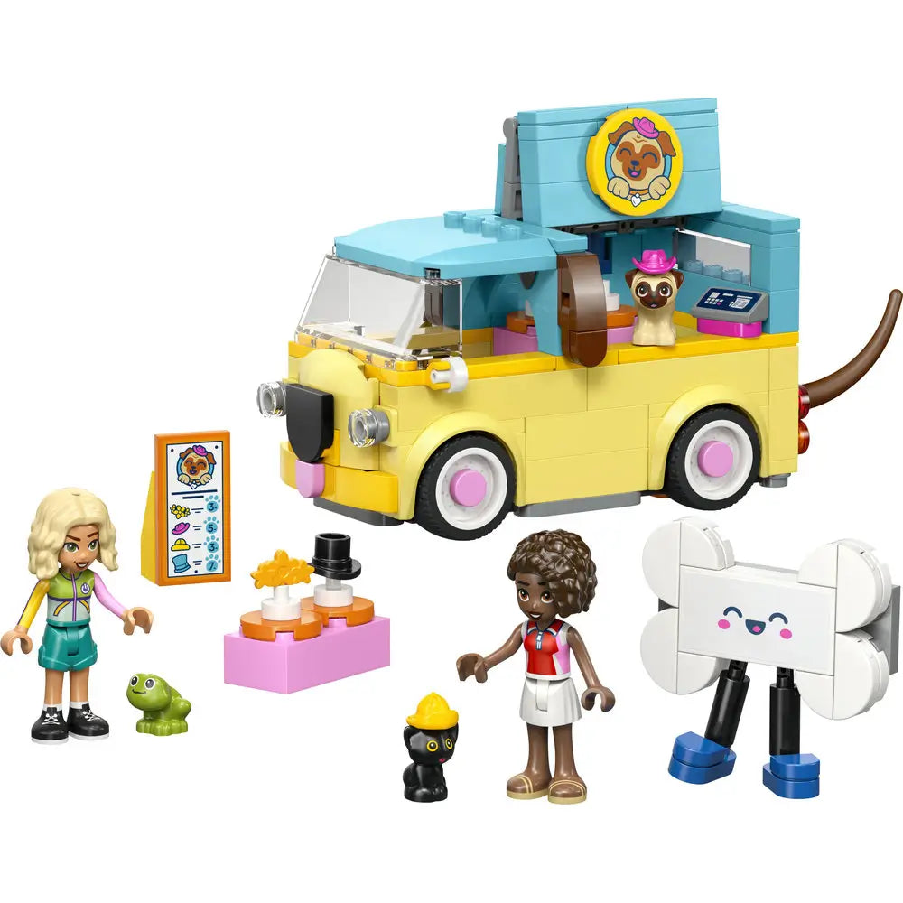LEGO Friends pet accessories van playset showing yellow and teal plastic bricks forming a dog themed service van with wheels, counter, accessories, pet figures, minidolls, and playful roadside care setting.