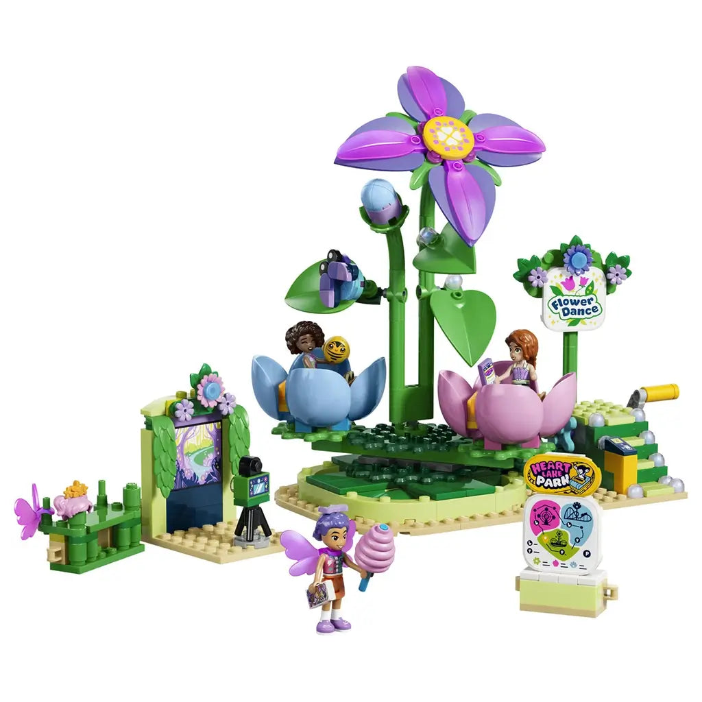 LEGO Friends Spinning Flower & Fairy Teacup Ride set 42702 features pink and blue flower seats, a tall purple flower, three mini-dolls, a camera and colorful park signs on white.
