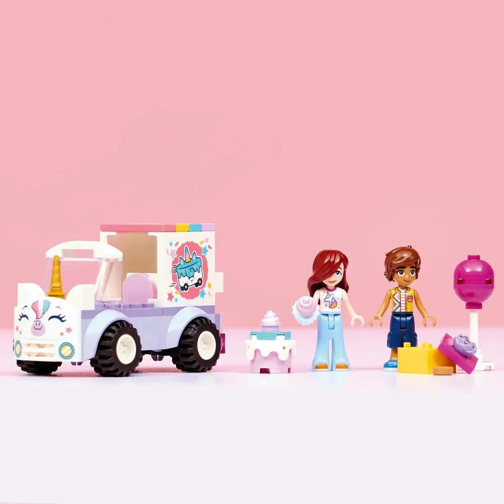 LEGO Friends Unicorn Cake Delivery Car set displayed in a row features pastel purple truck, unicorn face front, mini-doll characters, cake stand, gift box, and lollipop accessory arranged neatly against a light pink studio background.