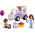 LEGO Friends Unicorn Cake Delivery Car toy features pastel purple, white, and pink plastic blocks forming a small delivery truck with unicorn face details, rolling wheels, cake accessories, and two mini-doll figures shown on a clean white background.
