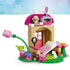 LEGO Gabby's Dollhouse garden house in pink, tan and green plastic bricks, opened to show a bed, drawer, mirror, flower table, watering can and small fairy cat figure.