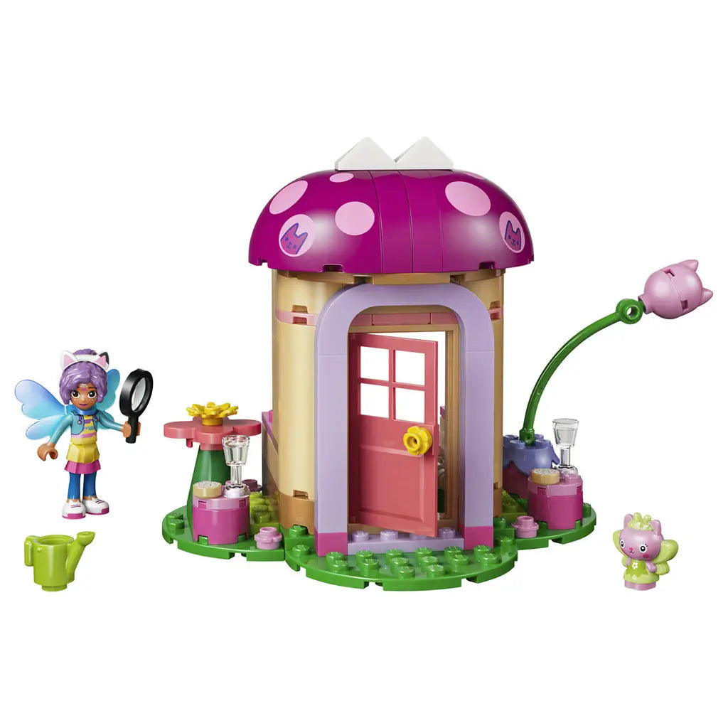LEGO Gabby's Dollhouse Kitty Fairy's Garden House in pink, tan and green plastic bricks, with mushroom roof, pink door, fairy figure, cat character and garden accessories.