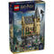 Front of LEGO Harry Potter Hogwarts™ Castle: Hospital Wing box showing a tall tan-and-gray castle tower with peaked roof, balcony, and rocky base, minifigures in action poses, and magical effects, presented on dark blue retail packaging with “25 Years of Magic” branding.