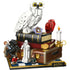 LEGO Harry Potter Philosopher’s Stone display model in white, red, brown, and gold plastic featuring Hedwig owl perched on stacked books, layered sculpted feathers, magical artifacts, and minifigures arranged on a decorative display base.