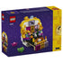 LEGO Altar of the Dead 40811 package back shows the opened white and yellow skull altar with colorful framed art, flowers, candles, bottles, and food offerings.