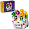 LEGO Altar of the Dead 40811 set pairs purple-and-yellow packaging with a white brick skull decorated with green, pink, orange, blue, and yellow flowers on white.