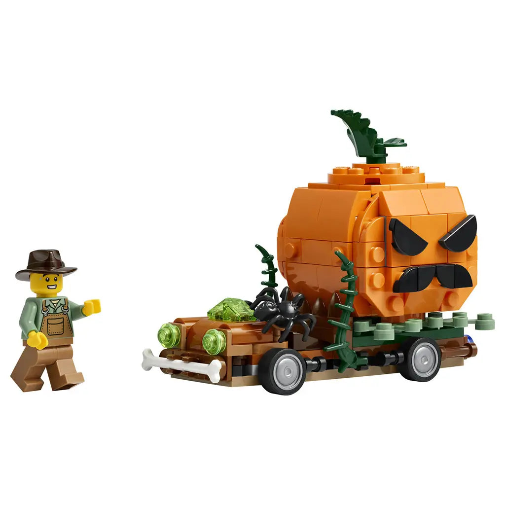 LEGO Jack-O'-Lantern Pickup Truck in brown and orange plastic bricks features a large angry pumpkin, green vines, black spider, bone bumper, and farmer minifigure on white.