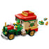 LEGO Santa’s Delivery Truck model shown in motion, with the elf minifigure driving and colorful gift pieces flying from the back as if being delivered.