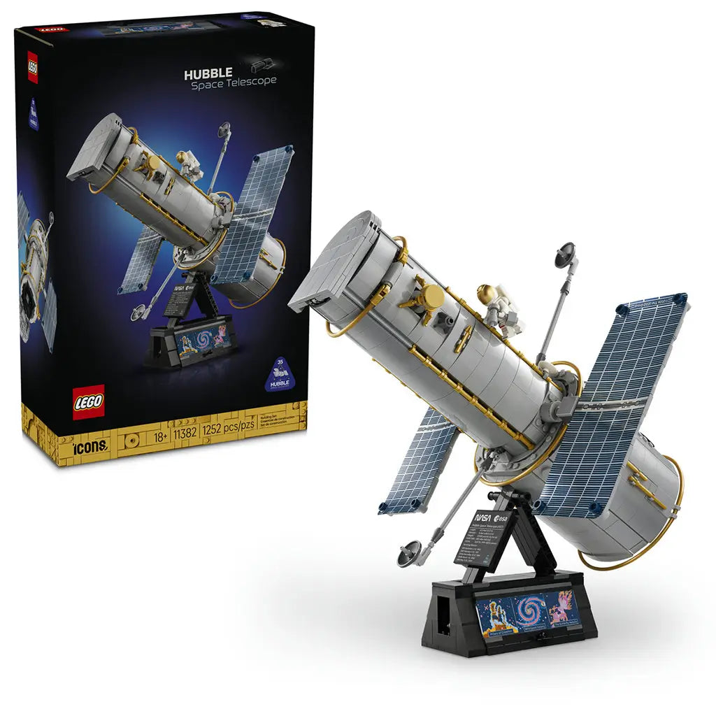 LEGO Icons Hubble Space Telescope 11382 set shows the gray, gold and blue brick-built telescope on a black display stand beside its black retail box on a white background.