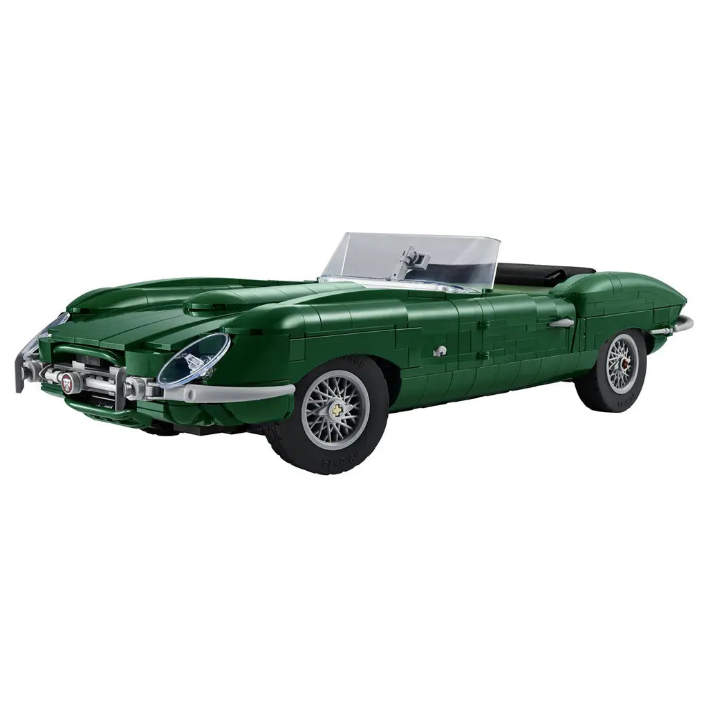 LEGO Icons Jaguar E-Type model features dark green plastic bricks, a long curved roadster body, clear windshield, silver wire wheels and black seats on a white background.